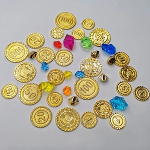 Close-up of golden pirate coins and multi-colored acrylic gems for board games