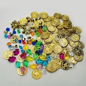 Close-up of golden plastic pirate coins and colorful resin gemstone board game pieces