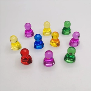 Close-up of ten colorful transparent resin game pawns in various bright vibrant colors