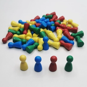 Close-up of smooth colorful plastic board game pawns in red yellow blue and green