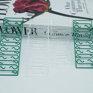 Detail showing green and transparent plastic S-hooks for Christmas tree ornaments