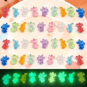 Detailed comparison of colorful luminous goldfish figurines in daylight and dark glow