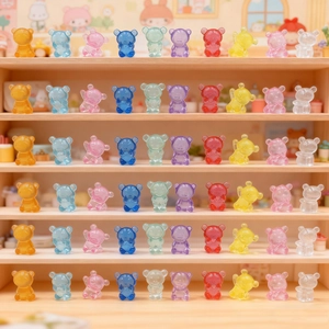 Close-up of colorful translucent resin bear figurines on wooden display shelves