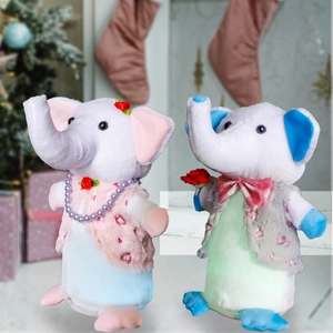 Pink and blue couple plush elephants with LED lights in a cozy Christmas setting