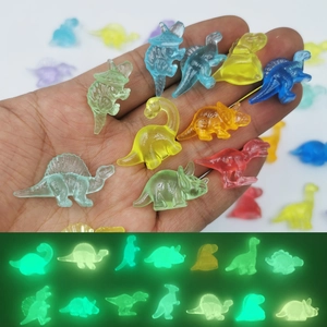 Glow-in-the-dark miniature resin dinosaurs in various colors shown in day and night