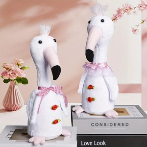 Pair of fluffy white flamingo plush toys with pink bows and floral details on pink books