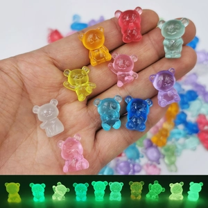 Luminous mini resin bears in multiple colors for DIY crafts shown in glowing dark mode