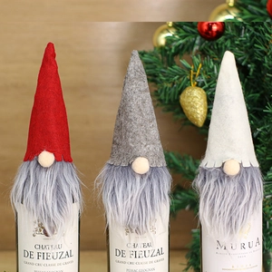 Three-piece set of Christmas gnome wine bottle covers in red, grey, and white felt