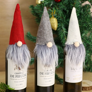 Three Christmas gnome wine bottle covers in red, grey, and cream knitted wool felt fabric