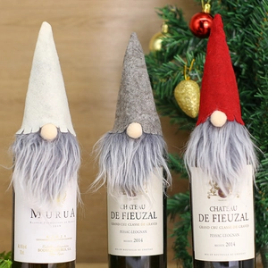 Three festive Christmas gnome wine bottle covers in white, grey, and red felt