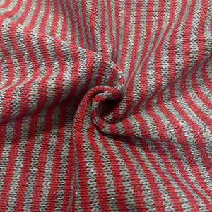 Close-up of red and grey striped knit fabric with soft wool-like ribbed texture