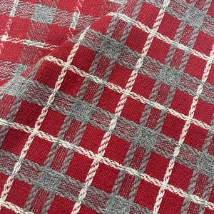 Macro detail of red and grey plaid knit fabric with soft texture for Christmas tree skirts