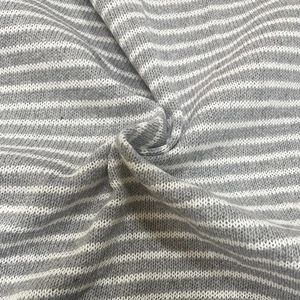 Close-up of grey and white striped knit fabric showing texture and soft folds