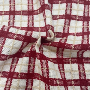 Detailed texture of red and white checkered knit fabric with thick woven yarn patterns