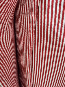 Macro shot of red and white striped knit fabric with soft rib texture for plush dolls