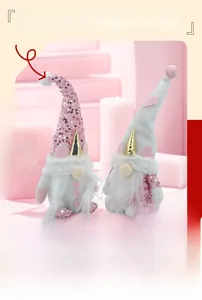 Close-up of plush gnome dolls with pink sequins and white fur on a pink background