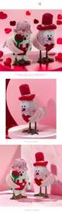 Detail of bird figurines with knitted hats, scarves and red heart for Valentine decor