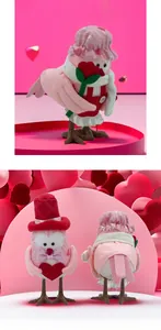 Macro detail of plush felt Valentine bird figures with pink hats and heart accessories