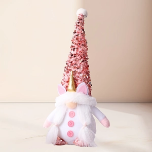 Detailed close-up of a pink sequined gnome plush with a unicorn horn and soft white beard
