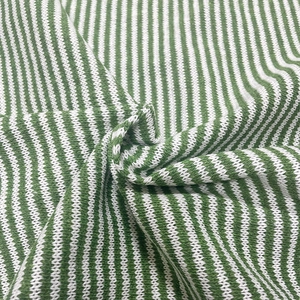 Close-up of green and white striped knit fabric showing detailed texture and soft weave