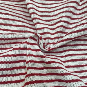 Detailed view of red and white striped knit fabric with soft texture and spiral fold