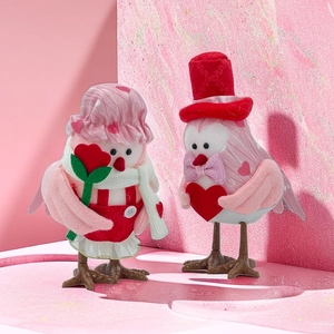 Charming Valentine's Day bird figurines with knit hats and heart decorations in soft pink
