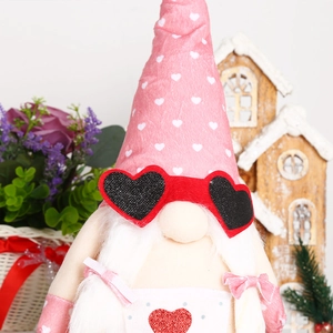 Detail of Valentine gnome with heart glasses and pink patterned hat for gift decor