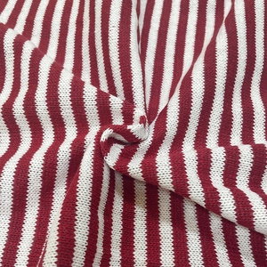 Close-up of red and white striped knit fabric showing soft texture and fine stitches