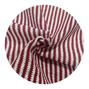 Detailed view of red and white striped knit fabric with a soft woven texture