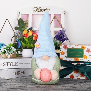 Easter gnome doll with blue knit hat holding a pink polka dot egg for home decor