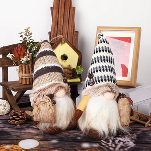 Pair of coffee-themed plush gnomes with knitted hats and coffee bean decor on a wooden stand