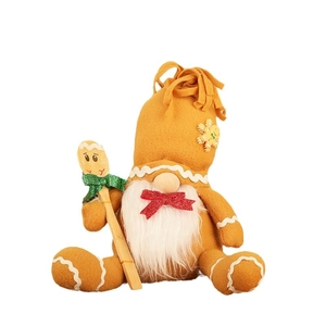 Gnome de Noël style pain d'épices avec barbe blanche, chapeau orange et cuillère en bois