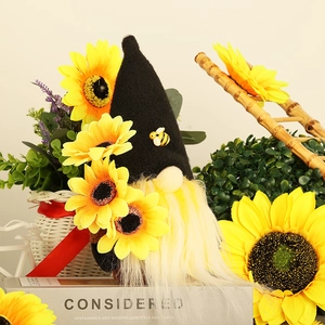 Detailed close-up of a sunflower gnome doll with plush beard and bee accents on book