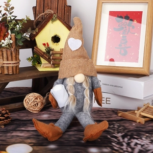 Knitted faceless gnome Christmas decoration with brown heart hat and gray felt body