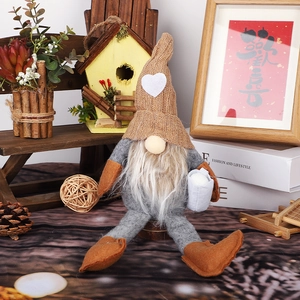 Detail of a Nordic Christmas gnome plush with a coffee cup in a cozy home setting