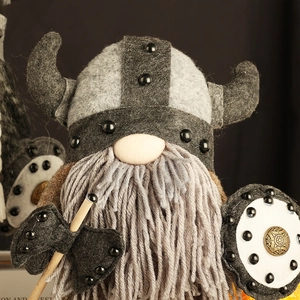 Detail of Viking gnome doll with horn helmet, felt shield and axe ornaments