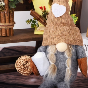 Knitted faceless gnome Christmas decoration with brown hat and gray felt body
