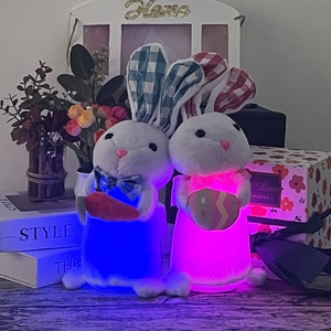 Light-up Easter bunny plush dolls with LED glowing carrot and egg on wooden table
