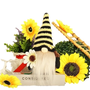 Handmade bee gnome plush with striped hat holding a white daisy for spring home decoration