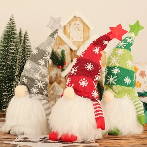 Three glowing Christmas gnomes with knitted hats and white fur beards for holiday decor