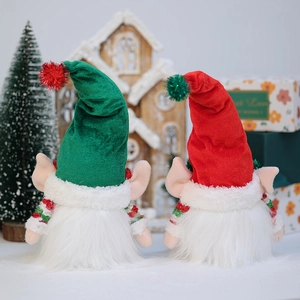 Set of two glowing Christmas gnomes with long pointed hats and white beards on wooden decor