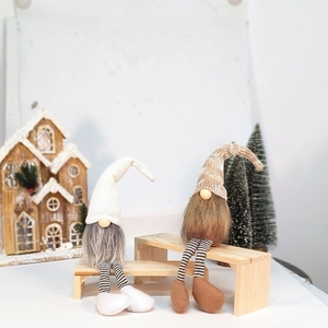 Close-up of long-legged Swedish Christmas gnomes with knitted hats and striped legs