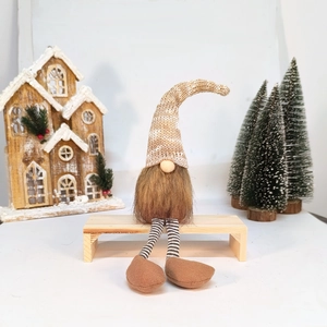 Detailed view of a Nordic Christmas gnome with a knitted hat and long striped legs