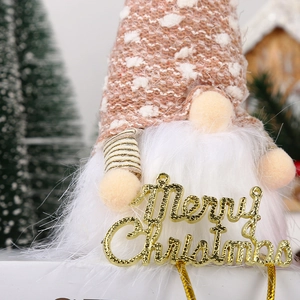 Pink plush Christmas gnome with sequin hat and golden Merry Christmas sign hanging