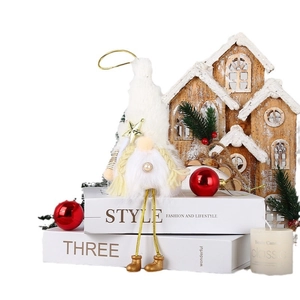 Christmas gnome doll with long legs and gold star hat on decorative books