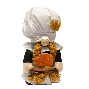 Detail of chef gnome plush with turkey tray and chef hat for Thanksgiving decor