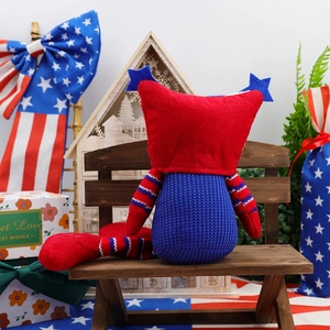 Detailed close-up of Independence Day gnome plush toy sitting on a mini wooden bench decor
