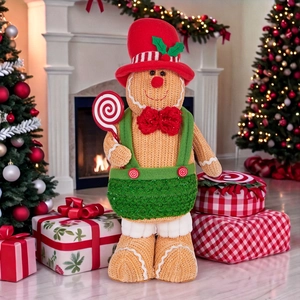 Standing gingerbread gnome plush doll in festive Christmas knitwear with lollipop decor