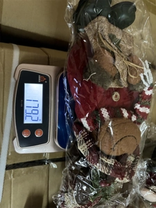 Linen Christmas Santa doll figure showing weight of 179.2g on digital scale