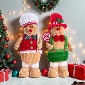 Detail showing a pair of knitted Christmas gingerbread dolls with a chef hat and candy cane
